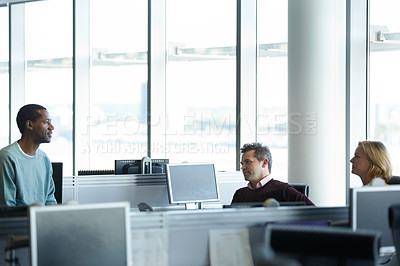 Buy stock photo Shot of a group of businesspeople talking in the office