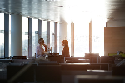 Buy stock photo Shot of two businesspeople talking in the office