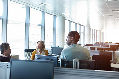 Buy stock photo Shot of a group of businesspeople talking in the office