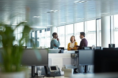 Buy stock photo Shot of a group of businesspeople talking in the office