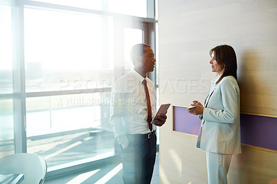 Buy stock photo Cropped shot of two businesspeople talking in an office