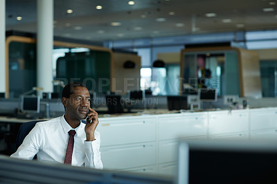 Buy stock photo Shot of a businessman using his cellphone in an office