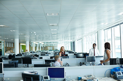 Buy stock photo Shot of a group of businesspeople talking in the office