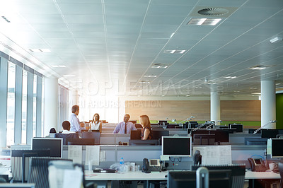Buy stock photo Shot of a group of businesspeople talking in the office