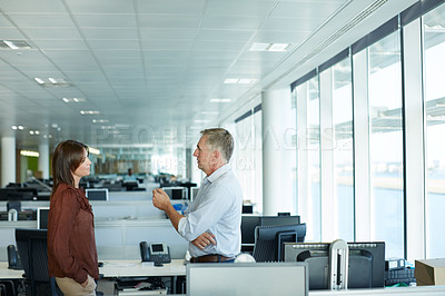Buy stock photo Shot of two businesspeople talking in the office