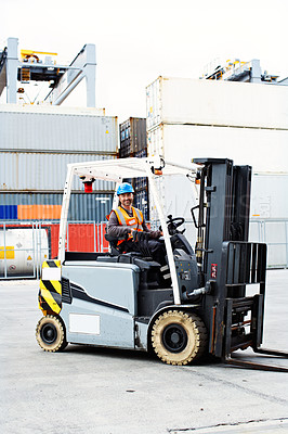 Buy stock photo Shot of a forklift operator working on a large commercial dock