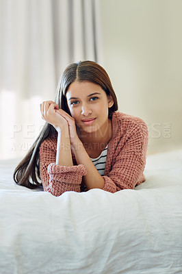 Buy stock photo Portrait of a young woman lying on her bed