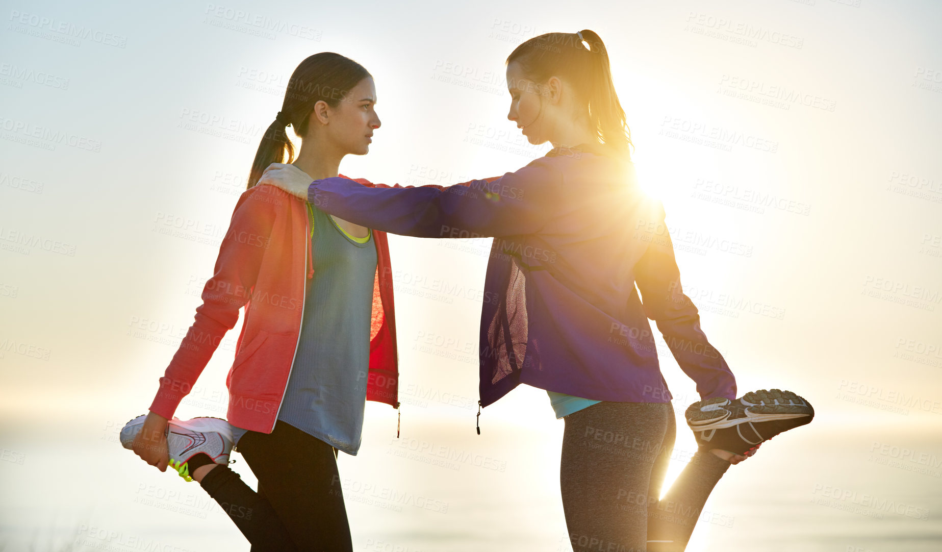 Buy stock photo Fitness, warm up and girl friends outdoor for run, exercise or wellness together in morning. Sports, bonding and women with leg stretching for workout, cardio or health on trail in nature by flare.