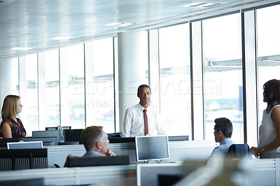 Buy stock photo Shot of a group of businesspeople talking together in the office