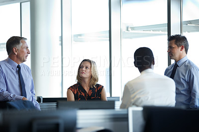 Buy stock photo Shot of a group of businesspeople talking together in the office