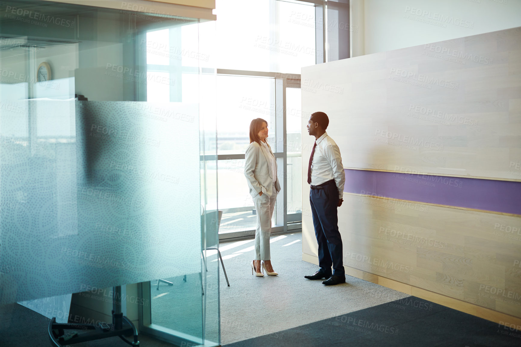 Buy stock photo Shot of two businesspeople talking together in an office