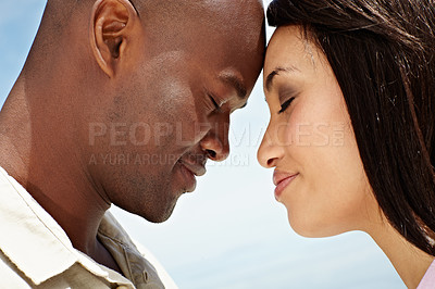 Buy stock photo Cropped shot of an affectionate couple enjoying a day outside together
