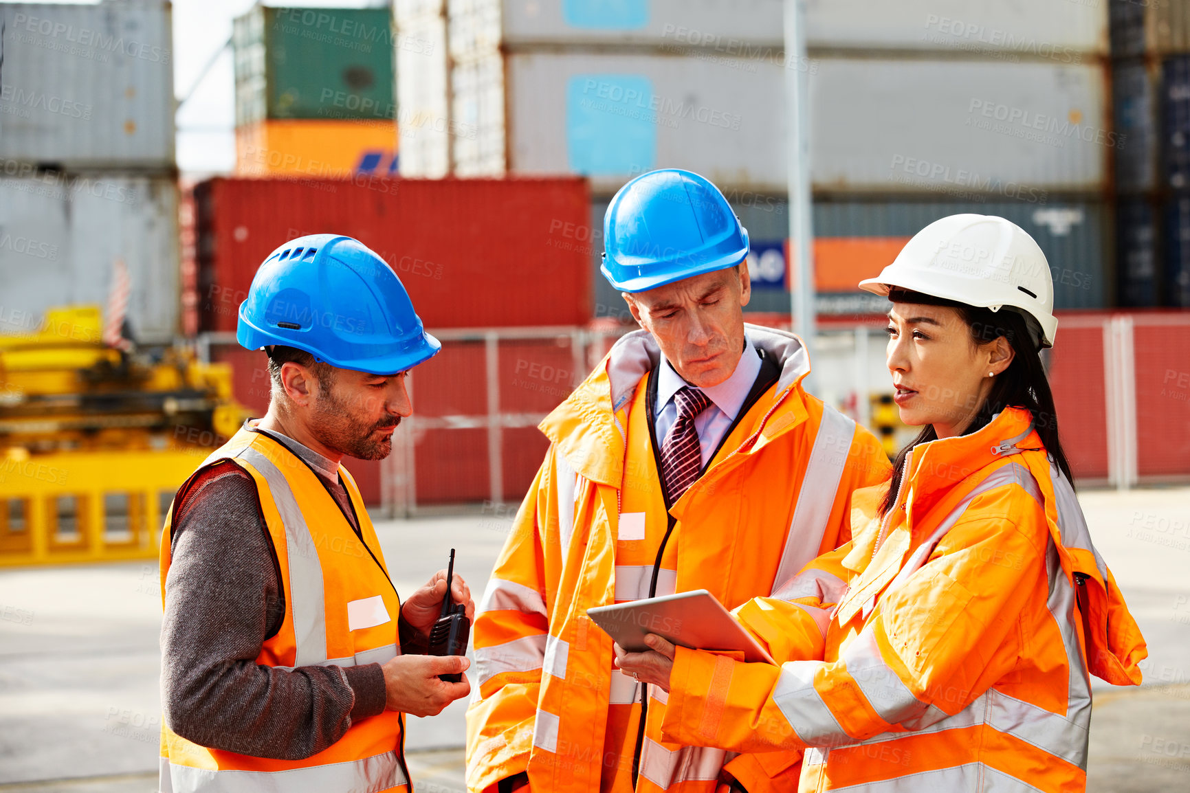 Buy stock photo Supervisor, team and discussion by shipping container with tablet, freight operations and logistics. Mature people, outdoor and talk with tech for supply chain, import update or coordination together
