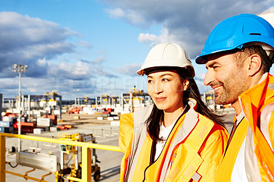 Buy stock photo Shot of two workers standing in a dockyard