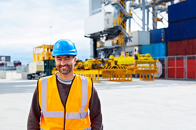 Buy stock photo Portrait of a young man in workwear standing outside on a large commercial dock