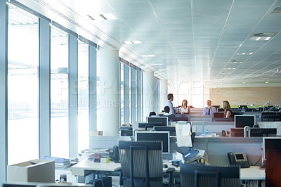 Buy stock photo Shot of a group of businesspeople talking together in the office