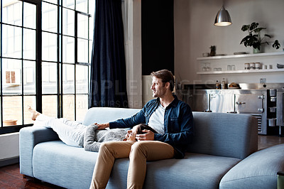 Buy stock photo Shot of a couple relaxing together on their living room sofa