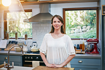 Buy stock photo Portrait of a smiling young woman standing in a kitchen
