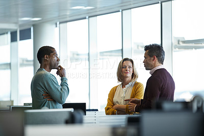 Buy stock photo Shot of a group of casually dressed businesspeople talking in the office