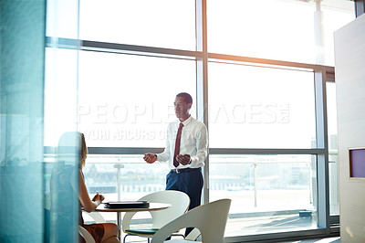 Buy stock photo Shot of two businesspeople talking together in an office