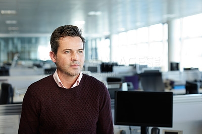 Buy stock photo Shot of a businessman standing in an office