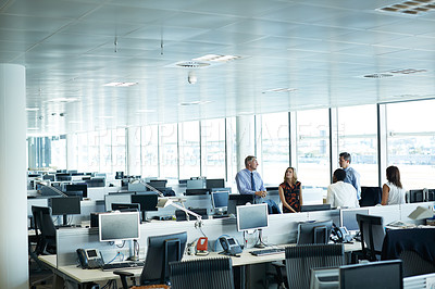 Buy stock photo Shot of a group of businesspeople talking together in the office