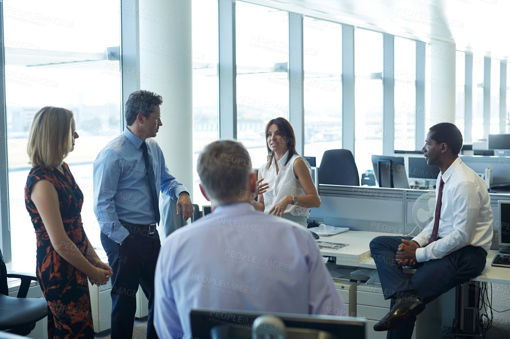 Buy stock photo Shot of a group of businesspeople talking together in the office