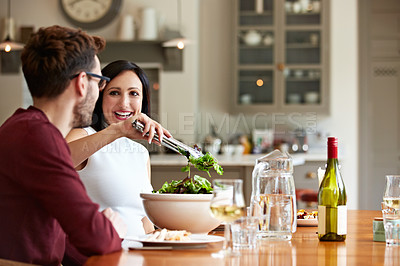 Buy stock photo Shot of a young couple having dinner together