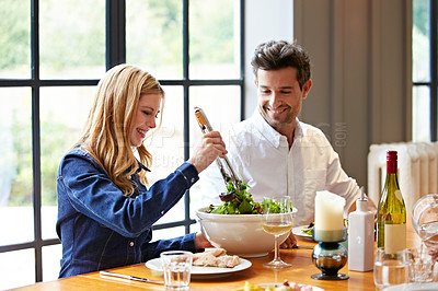 Buy stock photo Shot of a young couple having dinner together