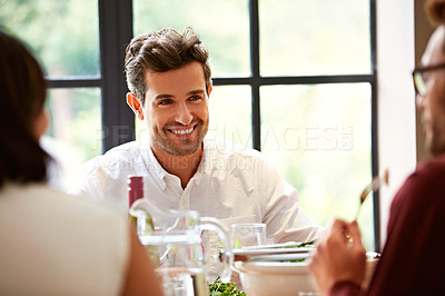 Buy stock photo Shot of a group of friends enjoying a home-cooked dinner together