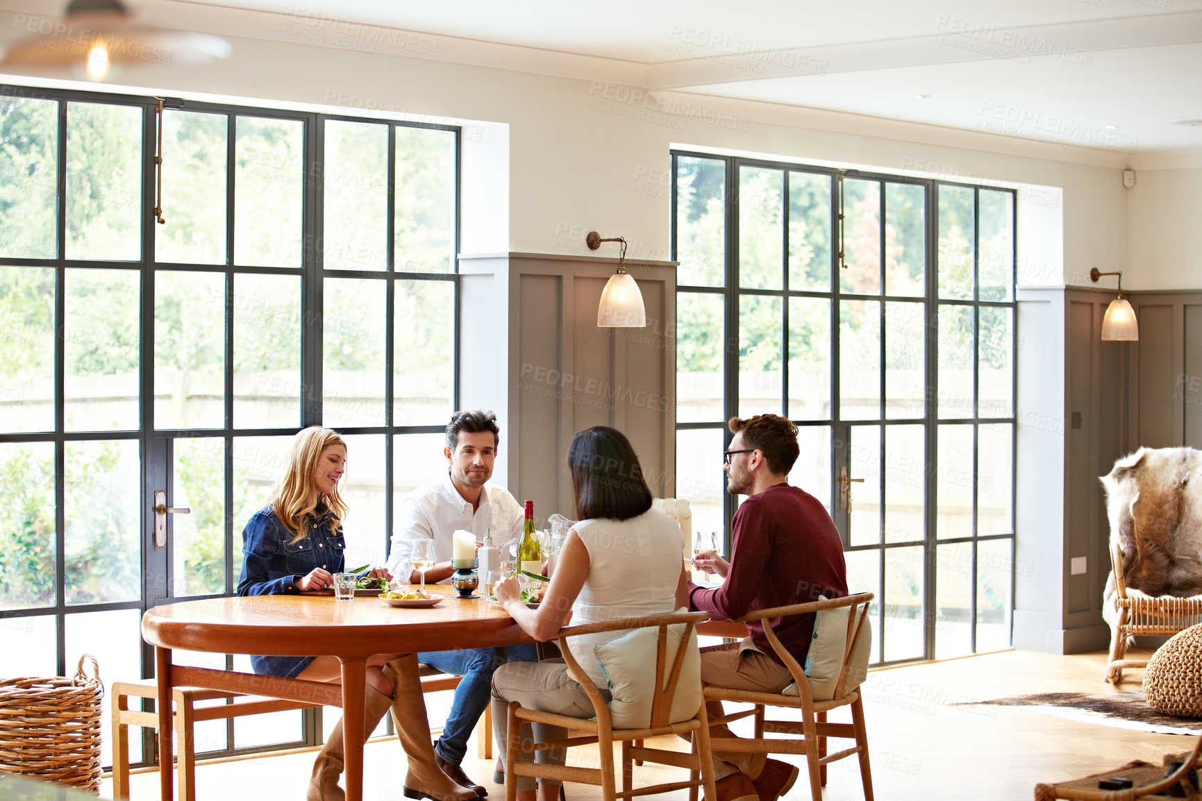 Buy stock photo Talking, home and couple of friends together for lunch, dinner gathering or meal on weekend. Happy, house and people with food, drinks and conversation for bonding, connection or reunion for visit