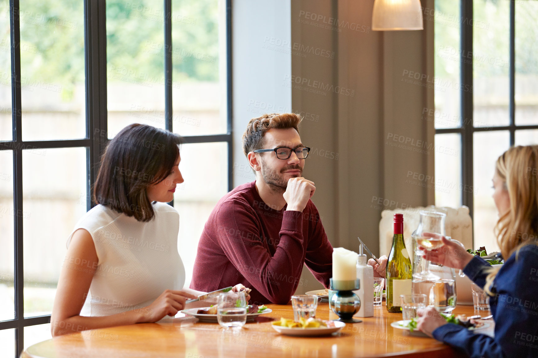 Buy stock photo Conversation, listening and friends in home for lunch, meal and bonding for social gathering. Happy, wine and men with women for hangout, talking and reunion for weekend, outing and dinner together
