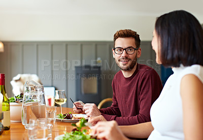 Buy stock photo Shot of a young couple having dinner together