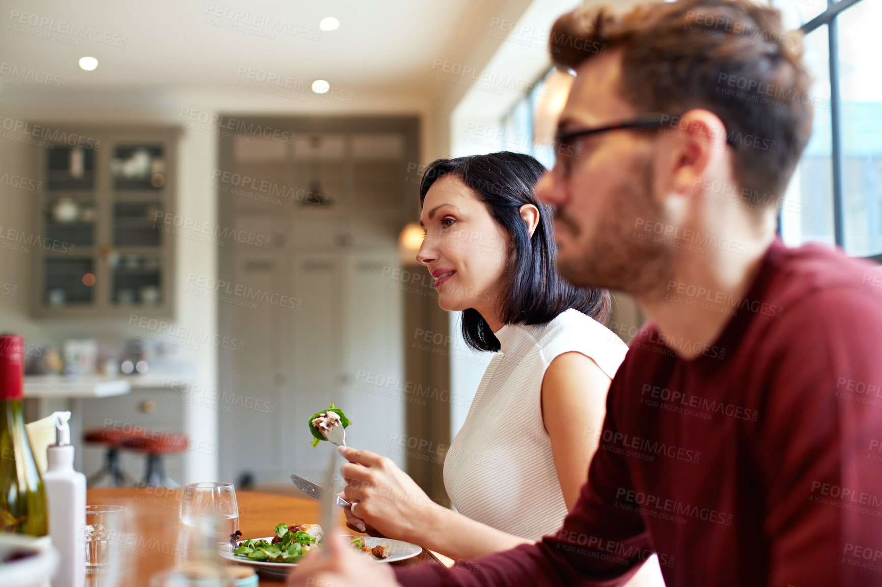 Buy stock photo Lunch, together and happy couple in dining room, connection or people with healthy food in apartment. Relationship, woman and man with meal, smile and brunch with partner and eating salad in house
