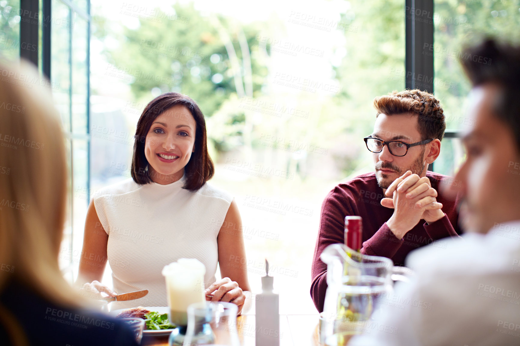 Buy stock photo Couple, chat and lunch with friends in dining room, relax together or discussion with group in house. Social gathering, home and happy people with meal, reunion and break with alcohol in apartment