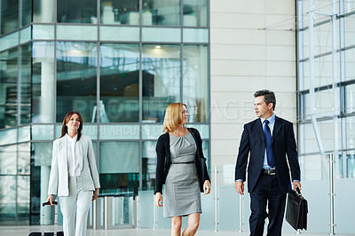 Buy stock photo Shot of businesspeople walking through the lobby of an office building