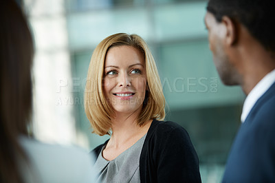 Buy stock photo Shot of businesspeople talking together in the lobby of an office building