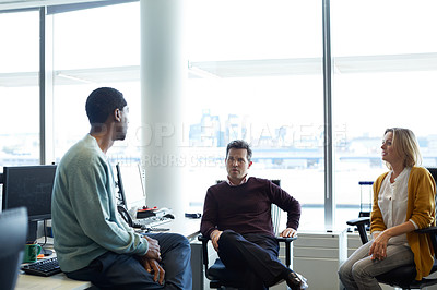 Buy stock photo Shot of a group of casually dressed businesspeople talking in the office