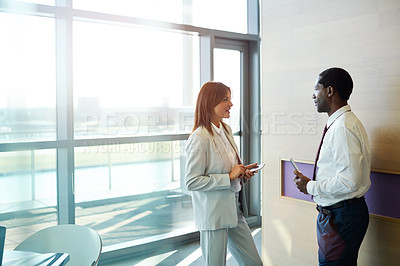 Buy stock photo Shot of two businesspeople talking together in an office