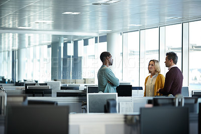 Buy stock photo Shot of a group of casually dressed businesspeople talking in the office