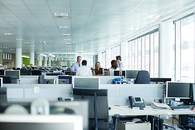 Buy stock photo Shot of a group of businesspeople talking together in the office