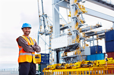 Buy stock photo Portrait of a young man in workwear standing outside on a large commercial dock