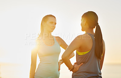 Buy stock photo Shot of two friends talking together after a cross country run