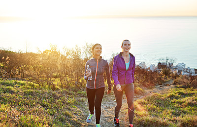 Buy stock photo Shot of two friends talking together while out for a cross country walk