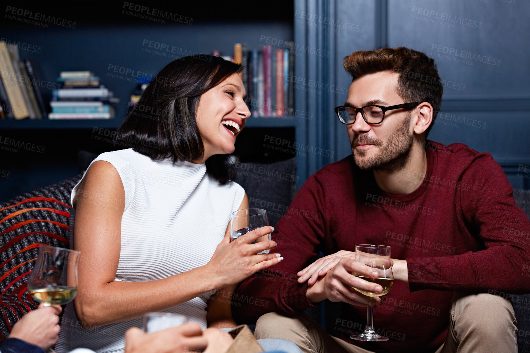 Buy stock photo Shot of a group of friends enjoying a night in together at home
