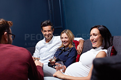 Buy stock photo Shot of a group of friends enjoying a night in together at home