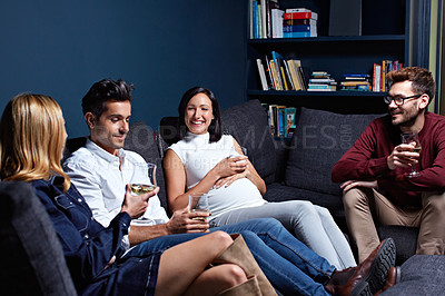Buy stock photo Shot of a group of friends enjoying a night in together at home