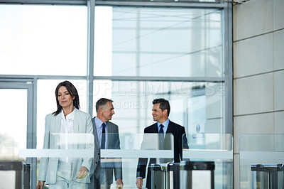 Buy stock photo Shot of businesspeople walking through the lobby of an office building
