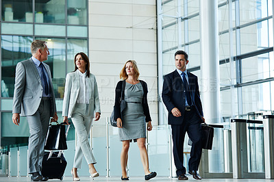 Buy stock photo Shot of businesspeople walking through the lobby of an office building