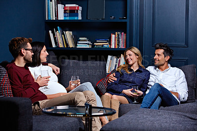 Buy stock photo Shot of a group of friends enjoying a night in together at home
